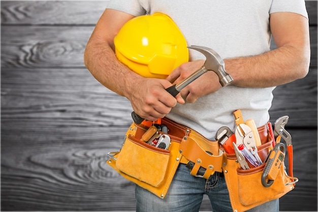 Handyman with a tool belt. House renovation service.