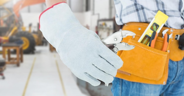 Handyman with tool belt at workshop