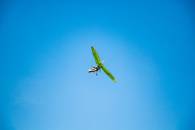 Hang glider in the blue sky. extreme dangerous sport, air\
flights.