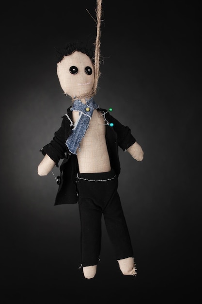 Hanged doll voodoo boygroom on grey background
