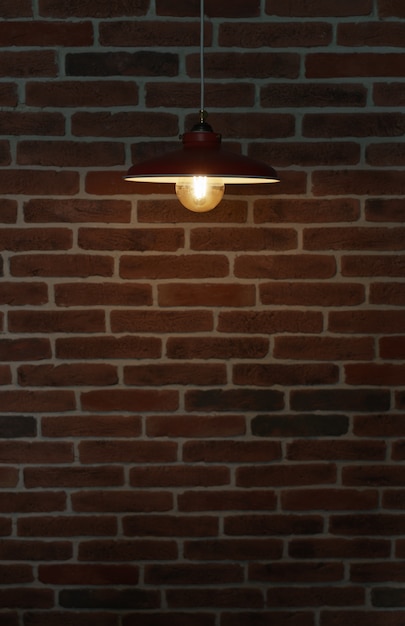 벽돌 벽에 교수형 된 램프 전구