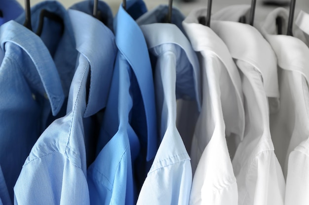 Photo hangers with clean shirts in laundry closeup