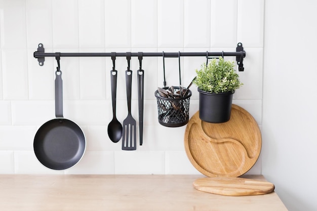 Photo hanging black kitchen utensils white wall