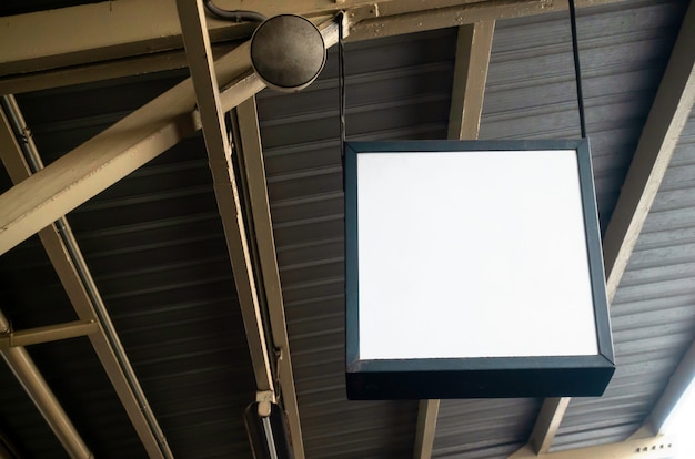 Photo hanging blank advertising billboard or light box showcase on wall at airport or subway train station