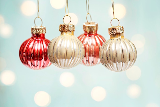 Hanging Christmas decorations on a background of defocused lights close up