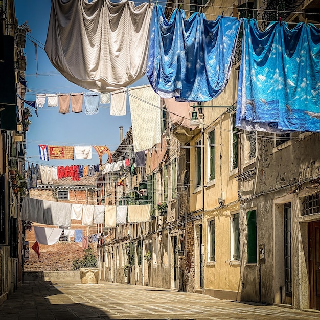 Hanging clothes put to dry on a small traditional street of Venice Italy Travel background