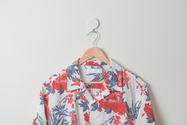 hanging colorful shirt with wood hanger on wall