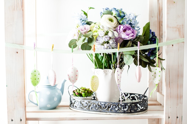 Hanging eggs on the ribbon - Easter decortaions on the shelf indoor