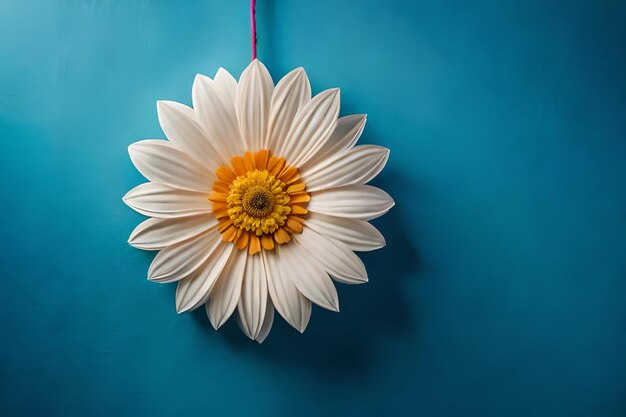 A hanging flower decoration with a red ribbon tied around it