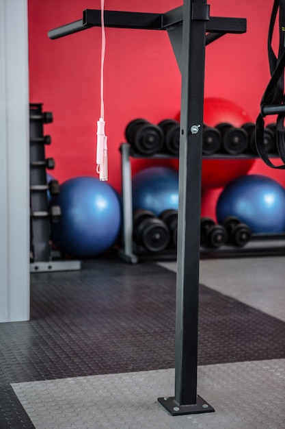 Hanging jump rope with exercise balls and weights behind them