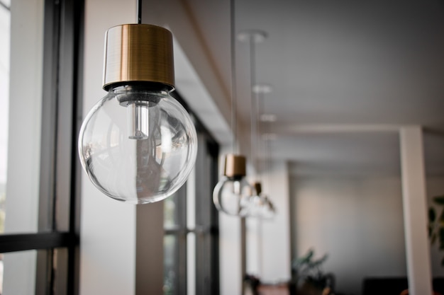 Hanging Light Bulb near glass window