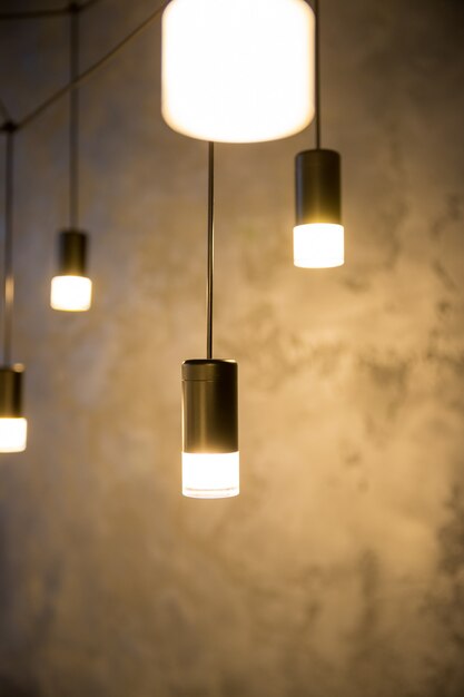 hanging retro incandescent lamp on a background of wooden blinds.Creative loft style lamp with