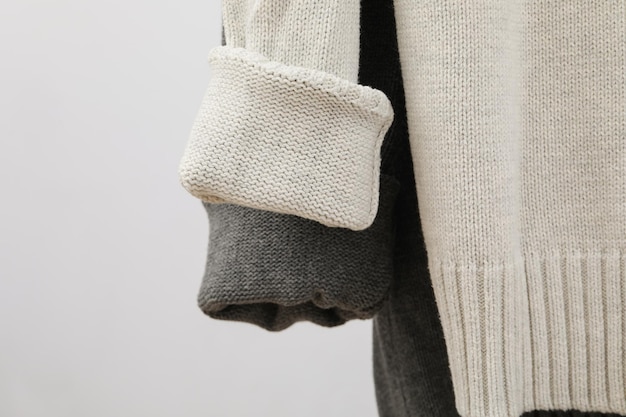 Hanging sweaters concept of autumn season clothes