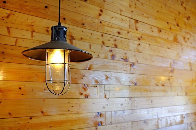 Hanging vintage style Lamp decor against wood wall.