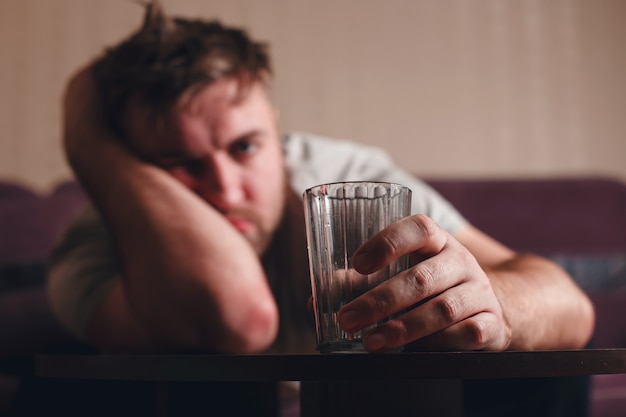 Hangover depressed man after hard drinking.