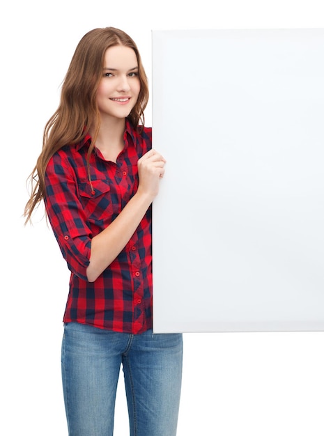 happiness, advertising and people concept - smiling teenage girl with white blank board