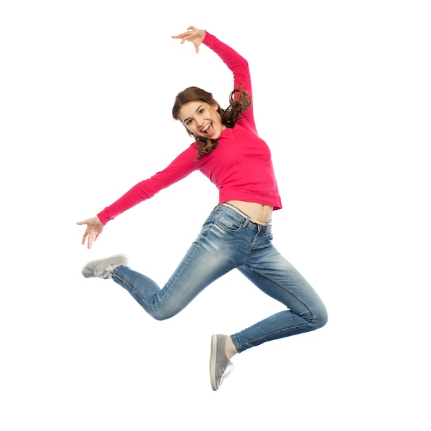 happiness, freedom, motion and people concept - happy young woman jumping or dancing in air over white background