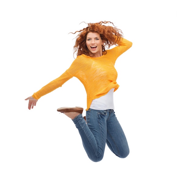 Photo happiness, freedom, movement and people concept - smiling young woman jumping in air