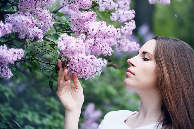 Happiness Girl smelling a lilac