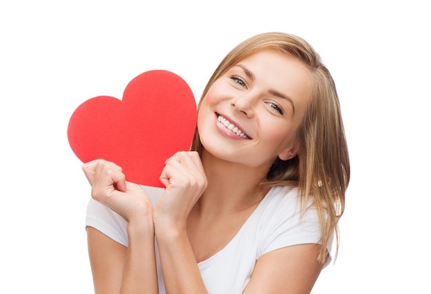 happiness, health and love concept - smiling woman in white t-shirt with heart