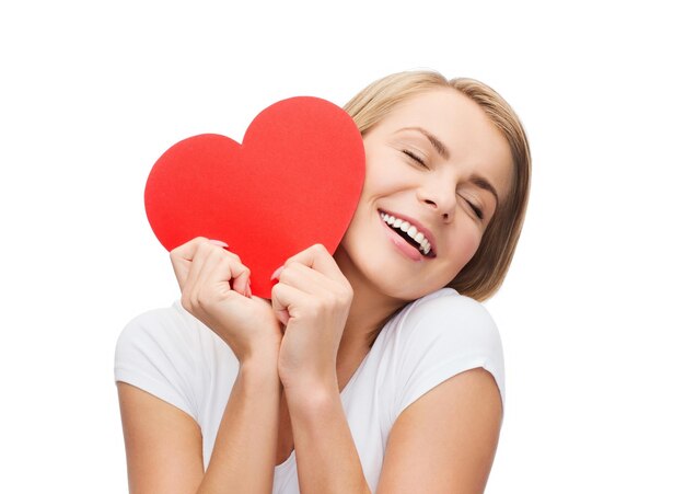 happiness, health and love concept - smiling woman in white t-shirt with heart