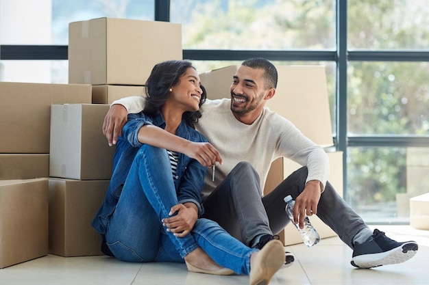 Photo happiness is homemade shot of a happy young couple moving into their new home together