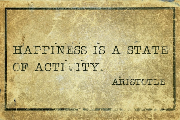 Happiness is a state of activity ancient Greek philosopher Aristotle quote printed on grunge vintage cardboard