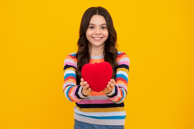 Happiness kids and love concept romantic lovely teen girl with\
red heart world heart day happy valentines day happy teenager\
positive and smiling emotions of teen girl