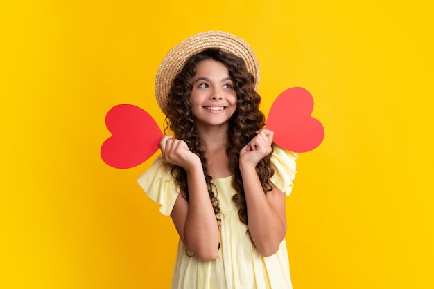 Happiness kids and love concept Romantic lovely teen girl with red heart world heart day happy valentines day Happy teenager positive and smiling emotions of teen girl