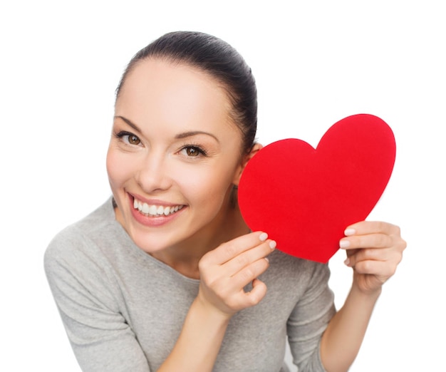 happiness, love and health concept - smiling asian woman with red heart