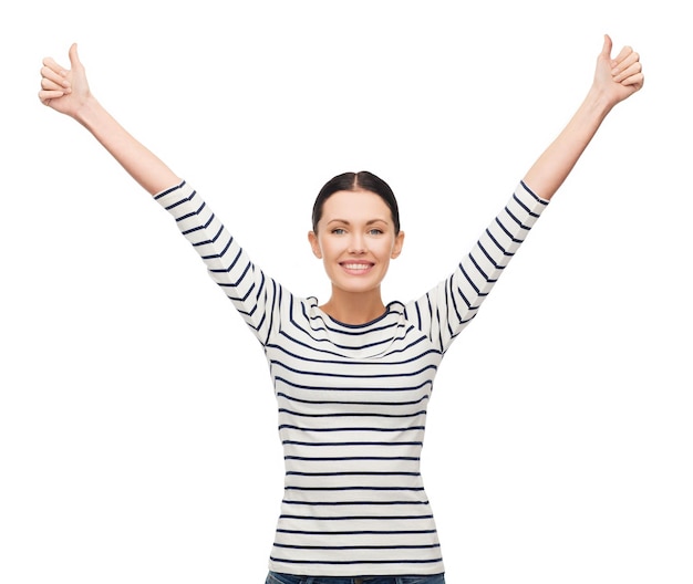 Photo happiness and people concept - smiling girl in casual clothes showing thumbs up