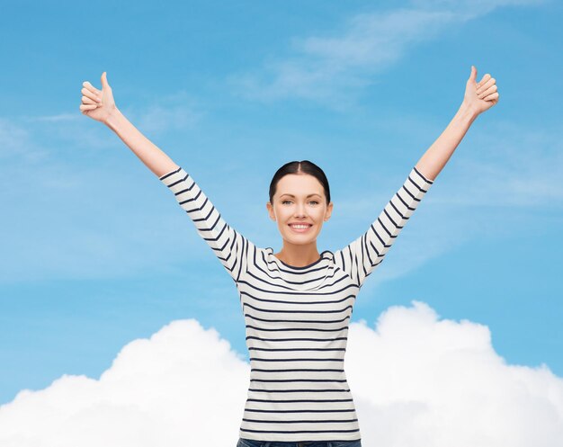 happiness and people concept - smiling girl in casual clothes showing thumbs up