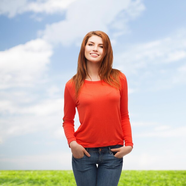 happiness and people concept - smiling teenager in casual top and jeans outdoors