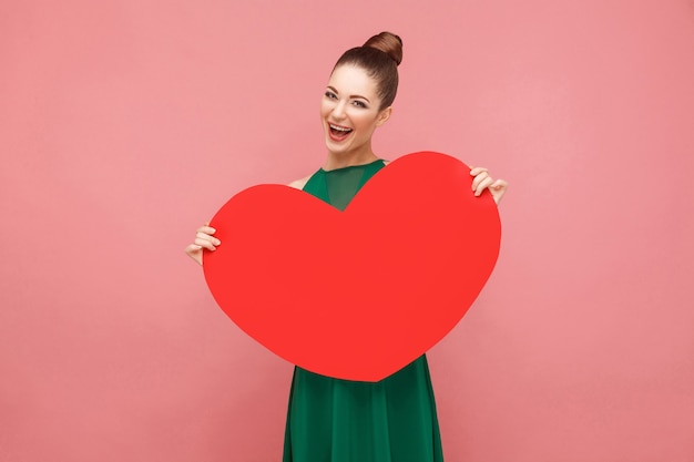 Happiness woman holding big red heart toothy smiling