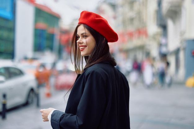 La donna della felicità salta e corre seguimi passeggiate passeggiate in città sullo sfondo di edifici per uffici abiti vintage alla moda alla moda e trucco primavera passeggiata viaggio