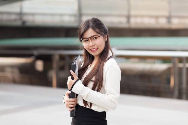 Happly asian businesswoman hold paper.