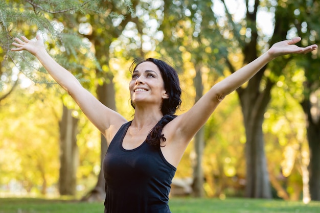 Happt brunette woman in a park