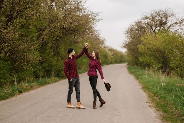 Happy active couple walking and have fun on the country side road