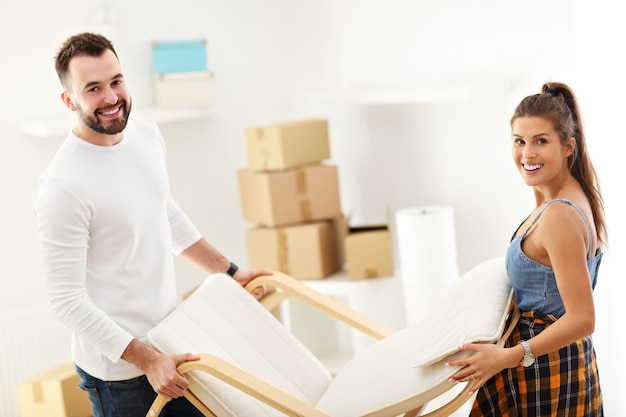 happy adult couple moving out or in to new home