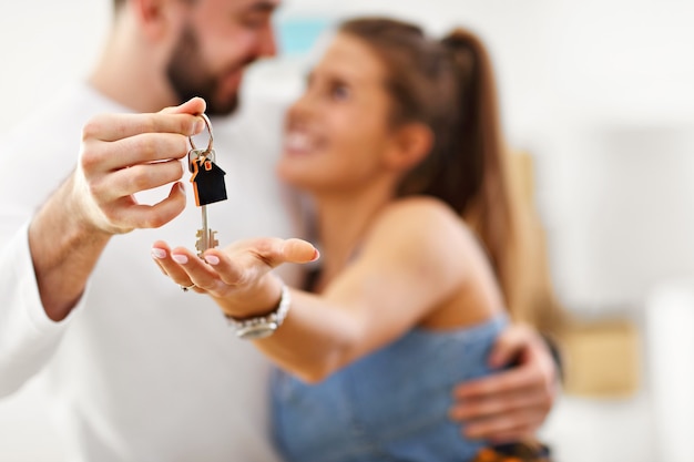 happy adult couple moving out or in to new home