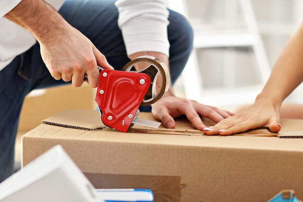 happy adult couple moving out or in to new home