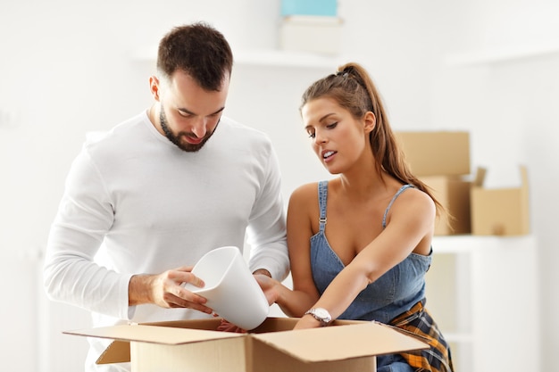 happy adult couple moving out or in to new home