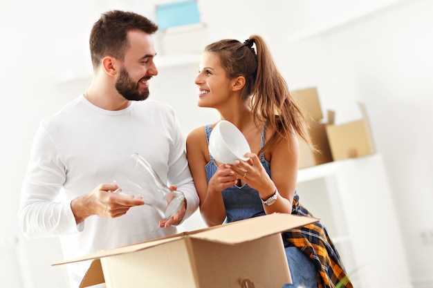 happy adult couple moving out or in to new home