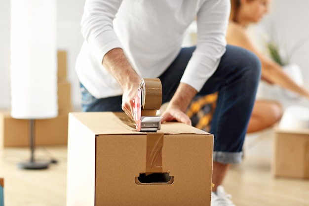 happy adult couple moving out or in to new home