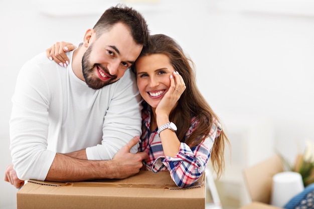 happy adult couple moving out or in to new home