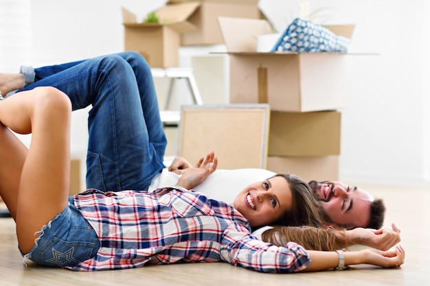 happy adult couple moving out or in to new home