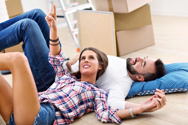 happy adult couple moving out or in to new home