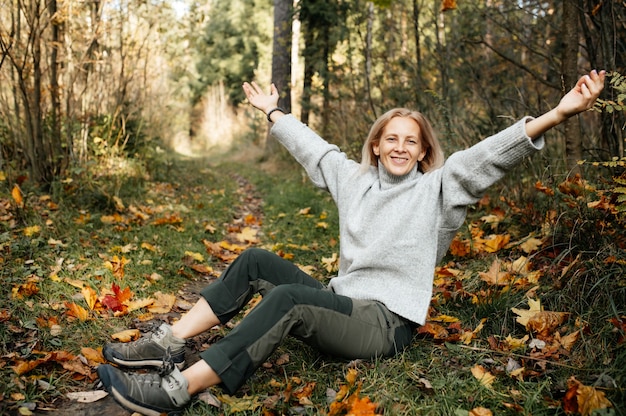 Happy adult woman in autumn forest