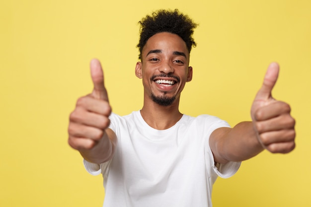 Happy African-American Businessman isolated on yellow background.