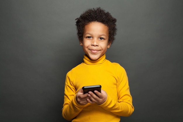 Happy African American child using smartphone